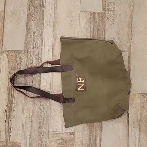 Cloth tote with NF initials. Leather (??) Strap